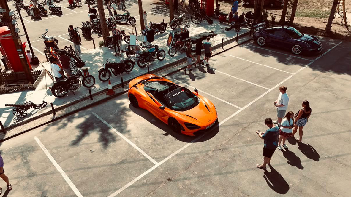 Aerial view of the venue with bikes on display and a McLaren