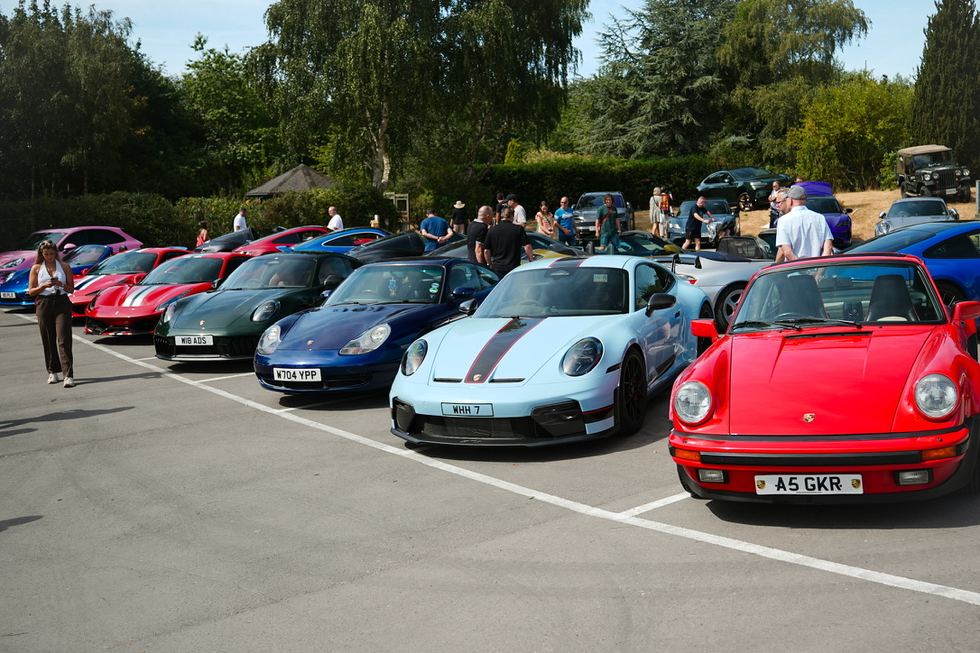 Row of cars and visitors browsing
