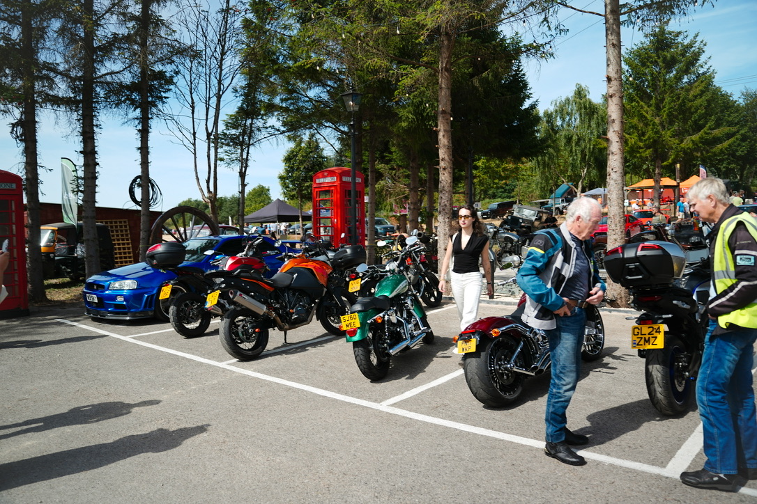 Motorbikes parked beside a red phone box
